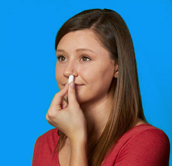 Image of woman using StopsBleeding™ Nosebleed strip