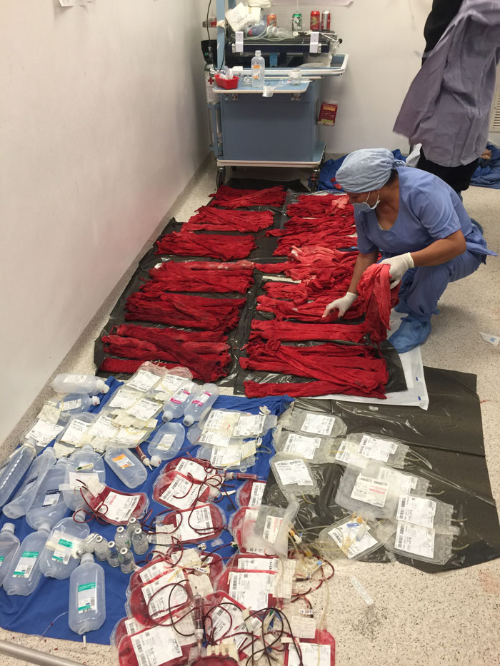 Image of bandages saturated with blood and empty blood containers